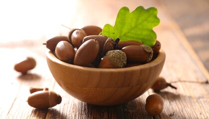 Wooden bowl of acorns with oak leaf