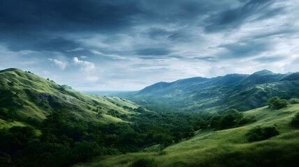Fototapeta premium A dramatic sky looms over a vast rolling green landscape with a dense forest filling the valley between the majestic hills