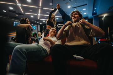 Friends gathering at a gaming lounge, engaged in video game activities, sharing fun moments, and...