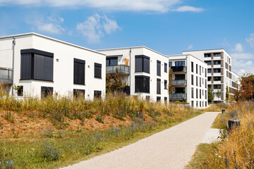 Modern Apartment Building Exterior with Autumn Landscape. New Luxury Residential Low-rise Building Block Complex Architecture in Germany. 