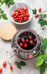 Rosehip herbal tea brewing in glass teapot