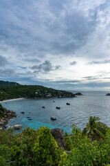 View of Shark Bay with boats and lush tropical vegetation from John-Suwan Viewpoint, Koh Tao, Thailand