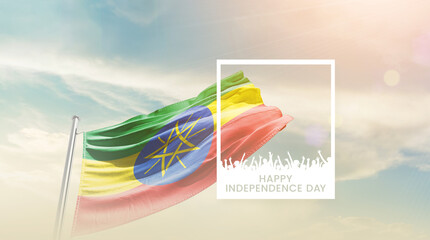 Ethiopia flag waving proudly under a bright sky with text happy independence day. Ethiopia national...