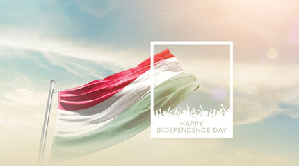 Hungary flag waving proudly under a bright sky with text happy independence day. Hungary national...