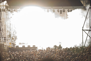 Crowd at concert and blurred stage lights.