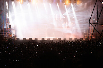 Crowd at concert and blurred stage lights.