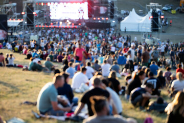 Blurred background of vibrant outdoor music festival