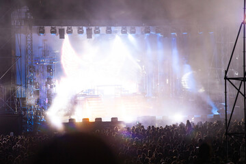 Crowd at concert and blurred stage lights.