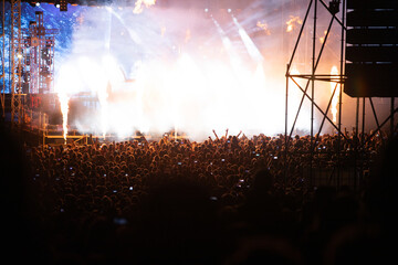 Crowd at concert and blurred stage lights.