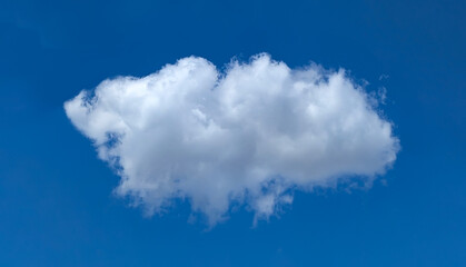 A lonely light cloud hovering above the ground on a dark blue background. Looking up at the sky in hopes of a sign from above. Gradual sailing with the wind in search oneself. Meditative picture.