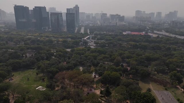 Aerial Reverse Drone Shot of Noida Cityscape and Urban Greenery &ndash; India