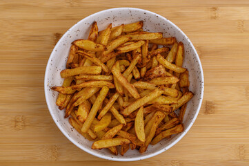 Crispy thin potato fries baked at home, without fat in an air fryer