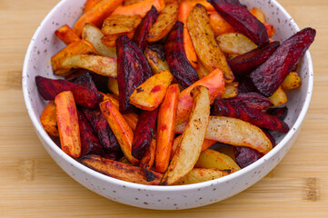 A bowl of air-fryer baked vegetables, a healthy dinner, potatoes, carrots, and beetroot