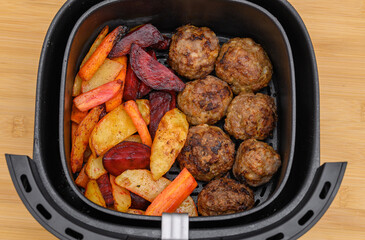 Air fryer dinner, baked vegetables with meat, meatballs