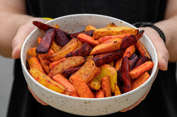 A healthy dinner, a bowl full of crunchy, baked, colorful root vegetables