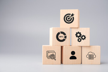 Stacked wooden blocks representing stages of data processing from raw data to analytics and decision making, symbolizing the flow from collection to insight