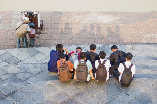 Portrait of a group of high school students and a drink vendor in the park, rear candid shot taken from above,