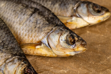 dried fish for storage by dehydrating whole fish in the sun, semi-finished product of dehydrated and dried fish in scales ready for human consumption