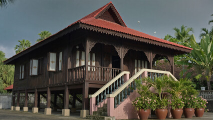 AI Generated: Traditional Malay Wooden House
A hyper-realistic cinematic wide shot of a majestic traditional Malay wooden stilt house with multiple gabled roofs. The house stands elevated on tall stil