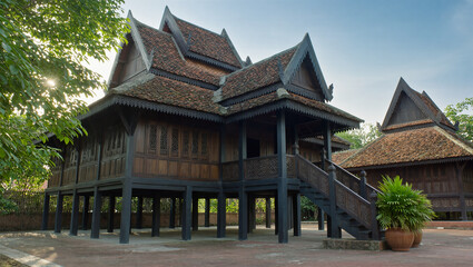 AI Generated: Traditional Malay Wooden House
A hyper-realistic cinematic wide shot of a majestic traditional Malay wooden stilt house with multiple gabled roofs. The house stands elevated on tall stil