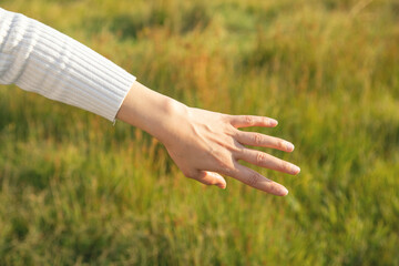 Young girl showing her hand in nature.