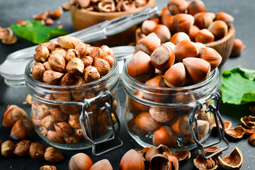 Organic shelled hazelnuts in a glass jar. Nut kernels. Close up.