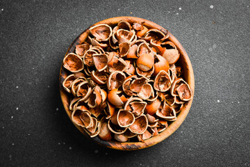 Nuts background. Hazelnut shell. On a dark stone background. Close up.
