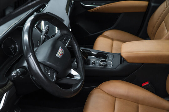 Cadillac XT4 I luxury SUV interior, seats, steering wheel, shift lever, dashboard. Beige and black interior of the subcompact luxury American SUV Cadillac XT4. 