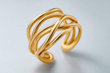 Naklejka premium A gold banded ring with a spiral design. The band is made of gold and is twisted