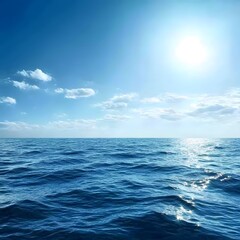 Tranquil ocean horizon under bright sunlit sky with scattered clouds