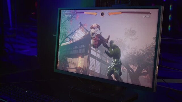 Video Game Fighter Jumps To Deliver Powerful Punch To Face Of Player Character. Powerful Ninja Fighter Defeats Shaolin Monk In Game. Computer Game Fighters On Screen. Powerful Kicks