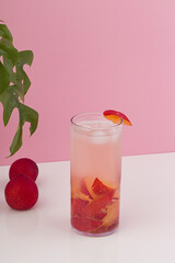Natural red plum juice isolated on pink background.