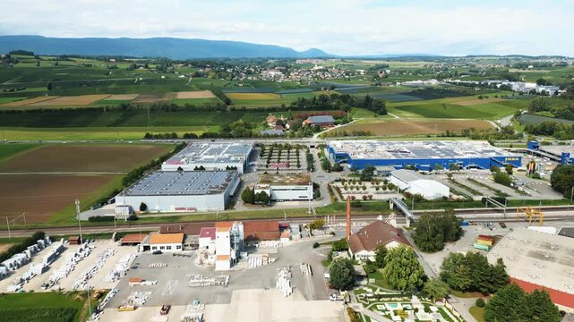 Aerial view of industrial buildings and the IKEA store blending with the landscape, creating a mix of industrial and natural beauty, Aubonne, Vaud, Switzerland.