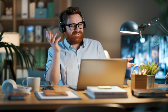Businessman wearing a headset and having a video call - Powered by Adobe