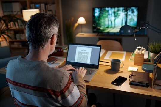 Man writing a text document with his laptop