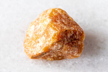 sample of raw heliolite sunstone mineral on white