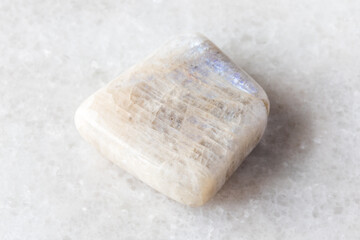 tumbled belomorite moonstone mineral on white