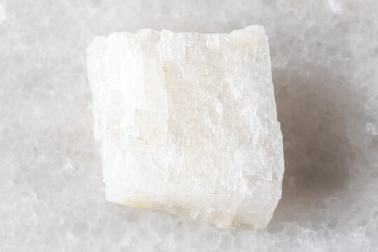 sample of raw colorless calcite rock on white