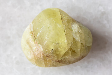 sample of polished saamite mineral on white marble