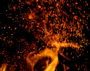 A fire is burning and the smoke is creating a lot of sparks