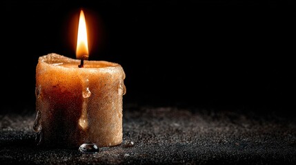 Glowing Candle with Melting Wax in Dark Environment Capturing Warmth and Serenity Amidst Shadows and Darkness