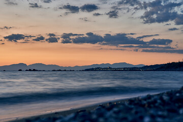 Serene Coastal Sunset with Mountain Range