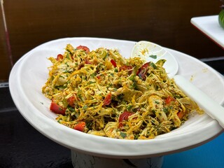 Salad or appetizer with chicken and vegetables. White bowl with spoon