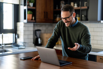 Businessman executive coach using laptop computer, having video conference call virtual meeting