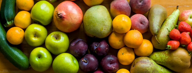 Healthy Fresh Fruits Food Nutrition Background with Apples, Pears, Plums, Strawberries, Peaches, Easy Peelers,Pomegranate, Mango, Courgettes