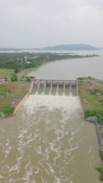Dolly-in aerial shot showing the water discharge of Pasak Chonlasit Dam in Lopburi Province, Thailand.