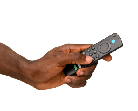 A hand holding a black remote control with multiple buttons, isolated on a transparent background.