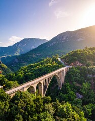 Mountain bridge at sunset. Lush valley below