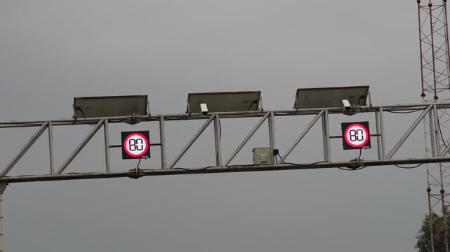 Highway speed limit gantry road sign with 80 km indicator - Powered by Adobe