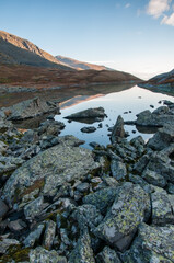 Morning view of lake Akchan in august with huge boulders on its shoreline, the Altai Republic, Russia